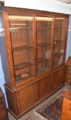 19th century mahogany library bookcase, moulded corners over three glazed doors enclosing fitted