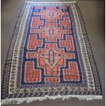 Kelim type large carpet, triple gull border, central panel with three orange geometric lozenges on a