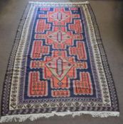 Kelim type large carpet, triple gull border, central panel with three orange geometric lozenges on a