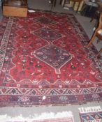 Large Shiraz type carpet, central panel with three interlinked lozenges, mainly red field, 2.94 x