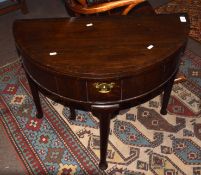 18th century oak tea table, demi-lune form with fold top, central frieze drawer raised on tapering