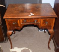 Queen Anne style walnut and walnut veneered small lowboy, the quartered veneered top with cross