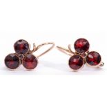 Pair of garnet earrings, each set with three circular cut garnets in collet settings with millegrain