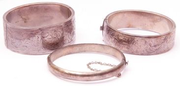 Mixed Lot: two hallmarked silver hinged bracelets, the wide bangle fully engraved with a scroll