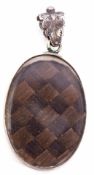 Antique mourning locket of oval form, glazed both sides with a plaited hair panel, engrave leaf