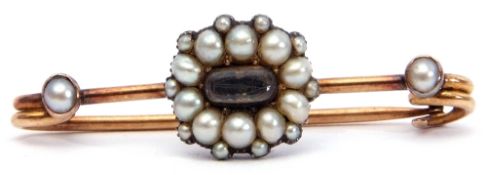 Mourning bar brooch, the centre an oval glazed plaited hair panel within a seed pearl surround, each