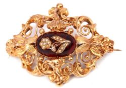 Antique yellow metal open work brooch of oval domed form with scroll and bead design, the centre a