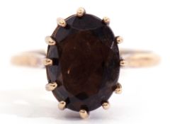 9ct gold smokey quartz ring of oval faceted shape, multi-claw set to a high basket collet, gross