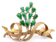 14K stamped jade brooch, a chased engraved scrolling vine design set with 11 oval shaped jade