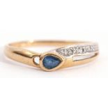 Modern sapphire and diamond ring, the pear shaped sapphire collet set highlighted with a pierced
