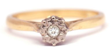 Single stone diamond ring, the small brilliant cut diamond in a star engraved setting, raised