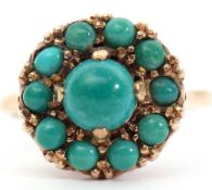 9ct gold and turquoise set cluster ring, the central cabochon stone within a surround of smaller