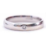 9ct white gold and diamond ring, set with a small brilliant cut diamond in an engraved setting,