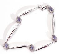 Modern precious metal sapphire and diamond set articulated bracelet, a design featuring 5 plain