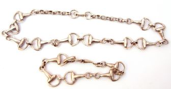 Matching white metal necklace and bracelet, a design with a stirrup and circular links, both stamped