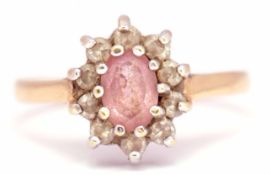 18ct gold pink topaz and diamond cluster ring, the oval pink topaz within a 10 small diamond