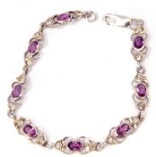 Modern white metal and amethyst set bracelet, featuring 8 links each with an oval faceted amethyst