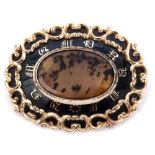 Victorian mourning brooch, the oval centre a moss agate panel on a black surround decorated with
