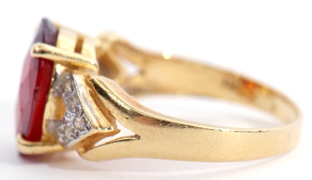 Modern garnet and diamond dress ring, the oval faceted garnet raised between diamond pierced - Image 2 of 7