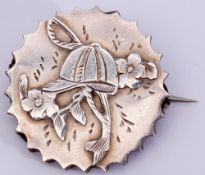 Victorian silver "jockey cap" brooch, the circular shaped brooch engraved and chased with a jockey