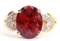 Modern garnet and diamond dress ring, the oval faceted garnet raised between diamond pierced