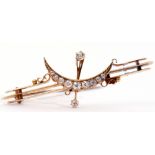 Vintage yellow metal and diamond crescent brooch, the triple knife edge bars centring a brilliant
