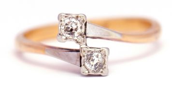 Precious metal two stone diamond ring, a cross over design featuring 2 brilliant cut diamonds in