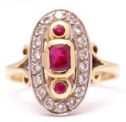 18ct gold ruby and diamond dress ring centring a stepped cut ruby between 2 round faceted rubies,