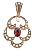 A 9ct gold garnet and seed pearl open work pendant, centring a collet and millegrain set oval