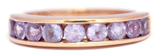 Modern 9K samped tanzanite ring, channel set with 9 round faceted tanzanites, size L