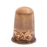 10ct stamped thimble, with pitted crown and chased engraved body, 3.8gms