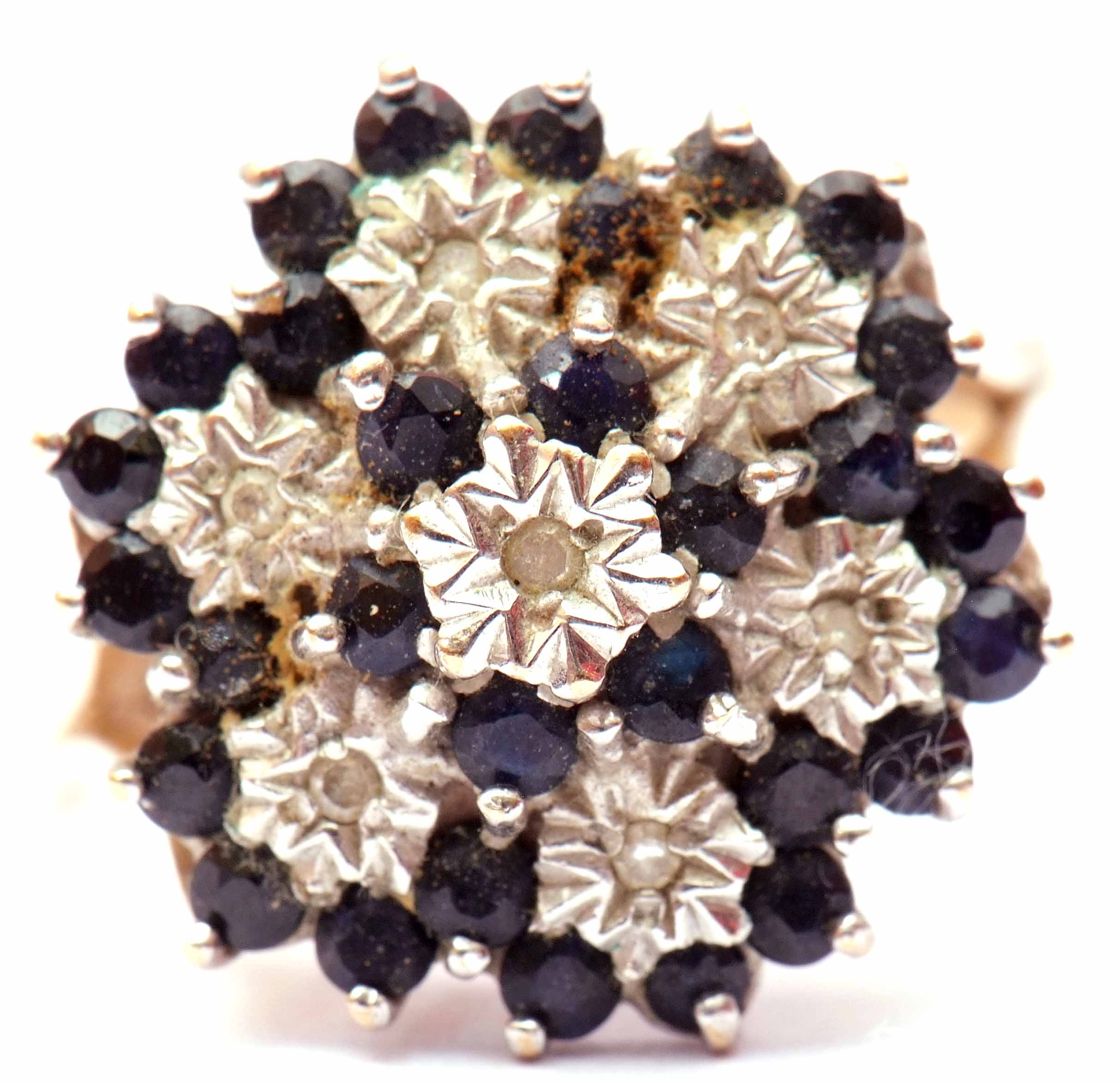 9ct gold, sapphire and diamond cluster ring, featuring seven small diamonds in illusion settings,
