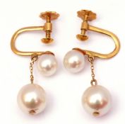 Pair of 18ct stamped pearl drop earrings featuring two graduated natural pearls, the larger drop 6mm