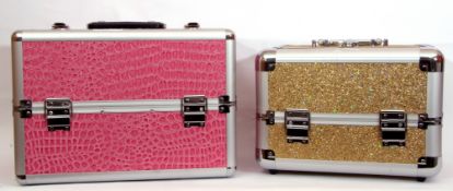 Two make-up/jewellery cases (void), pink leatherette and gold glitter designs