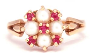 A 585 stamped seed pearl and ruby cluster ring, the 4 seed pearls interspersed with 4 small