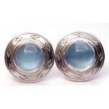 Pair of moonstone earrings, the circular cabochon moonstones framed in an engraved mount, the
