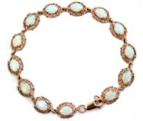 Modern 9ct gold and opalescent set bracelet featuring 13 oval cabochon opalescents, individually