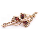 9ct gold, garnet and seed pearl brooch, a design of a three leaf clover entwined in a seed pearl