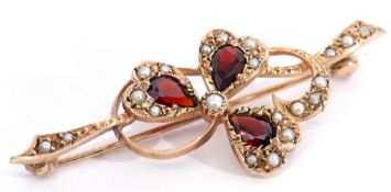 9ct gold, garnet and seed pearl brooch, a design of a three leaf clover entwined in a seed pearl