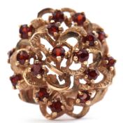 9ct gold garnet set dress ring, bombe style, comprising a series of 16 round faceted almandine