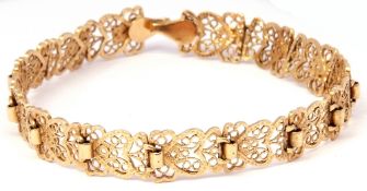 14K stamped "Arpas" filigree bracelet, the articulated links with an open work heart design, 18cm