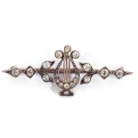 Antique lyre diamond set brooch, design featuring a central lyre on a knife edged bar, decorated