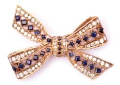 9ct gold diamond and sapphire tied bow brooch set throughout with calibre cut sapphires and single