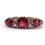 9ct gold garnet and diamond ring, featuring 3 graduated round faceted garnets, interspersed with 4