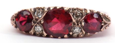 9ct gold garnet and diamond ring, featuring 3 graduated round faceted garnets, interspersed with 4