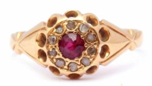 Early 20th century 18ct gold ruby and diamond ring, centring a round faceted ruby within a