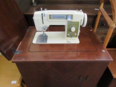 CIRCA 1960S TOYOTA ELECTRIC SEWING MACHINE IN A WOODEN CABINET