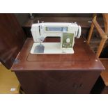 CIRCA 1960S TOYOTA ELECTRIC SEWING MACHINE IN A WOODEN CABINET