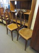 PAIR OF OVAL BACK HALL OR BEDROOM CHAIRS WITH CARVED RIBBON DETAIL AND CANE SEATS, HEIGHT 95CM