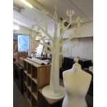 WHITE PAINTED ABSTRACT MODEL OF A TREE FORMED FROM TWO INTERLOCKED FLAT PANELS MOUNTED TO A CIRCULAR